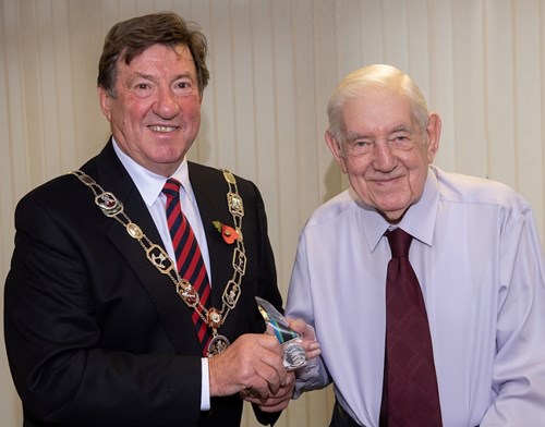 Chairman of Richmondshire District Council, Councillor Bill Glover, presents Jack with his Bevan medal.
