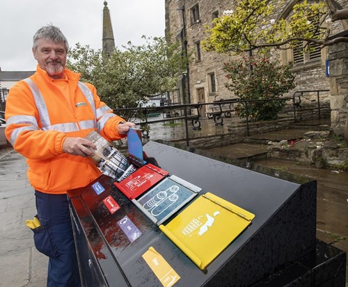 Waste and street scene team member, Kim Hesketh, tries out new bin