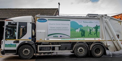 Bin truck with Visit Richmondshire Safely campaign banner