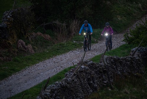 Image of cyclists at night using lights